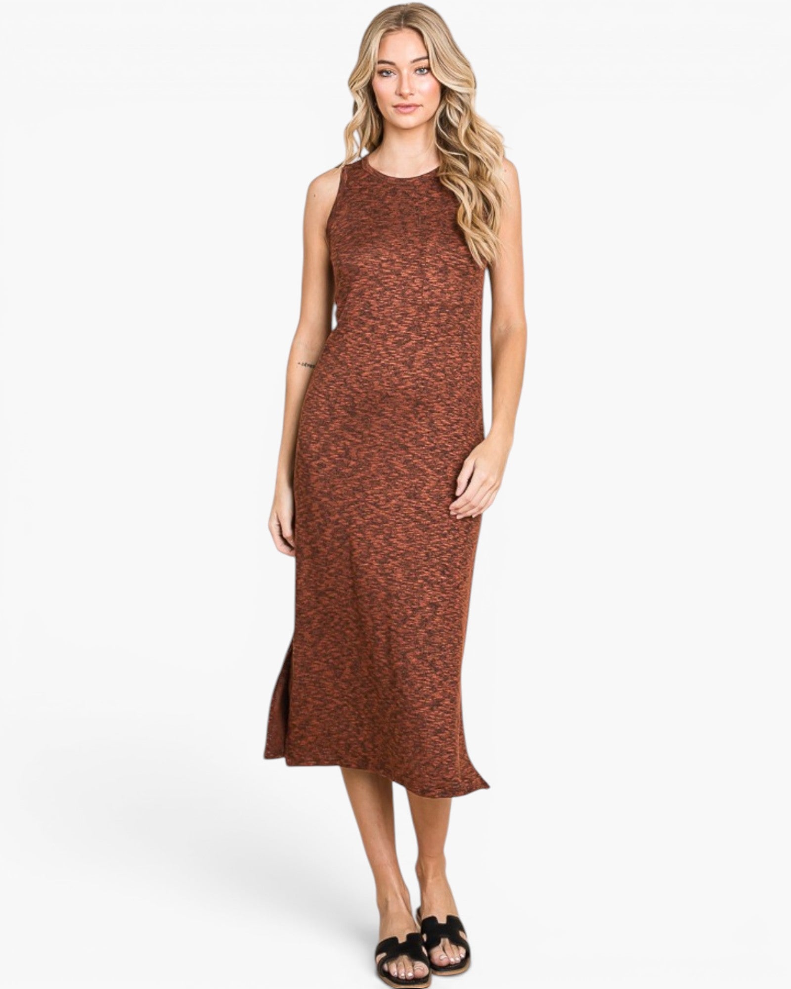 A woman modeling a sleeveless rust-brown midi dress with a subtle textured pattern, standing against a plain white studio background.