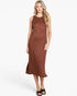 A woman modeling a sleeveless rust-brown midi dress with a subtle textured pattern, standing against a plain white studio background.