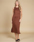 Woman wearing a brown sleeveless dress against a beige background