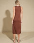 Woman wearing a brown sleeveless dress against a beige background