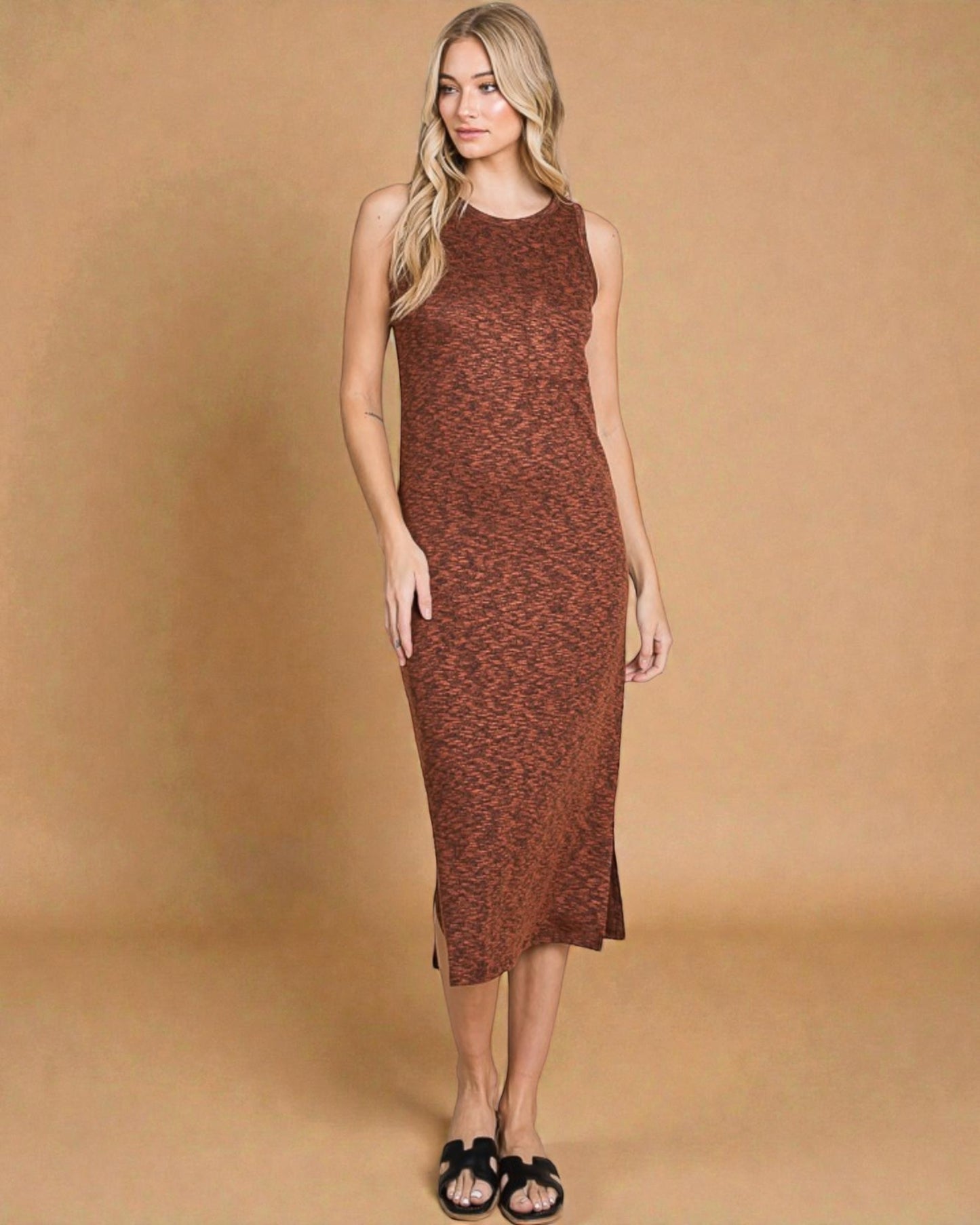 Woman wearing a brown patterned dress against a beige background