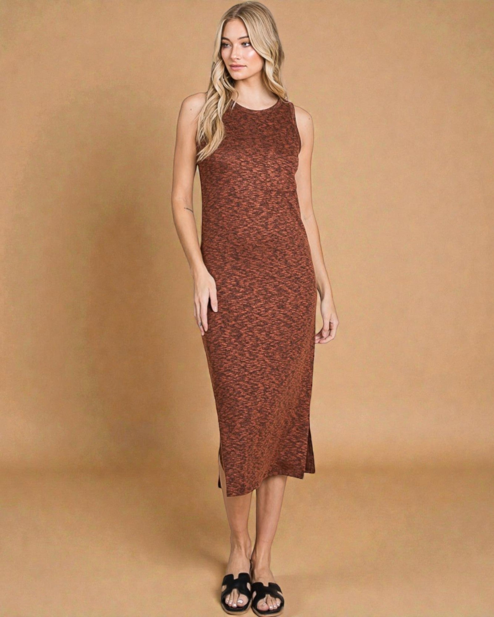 Woman wearing a brown patterned dress against a beige background