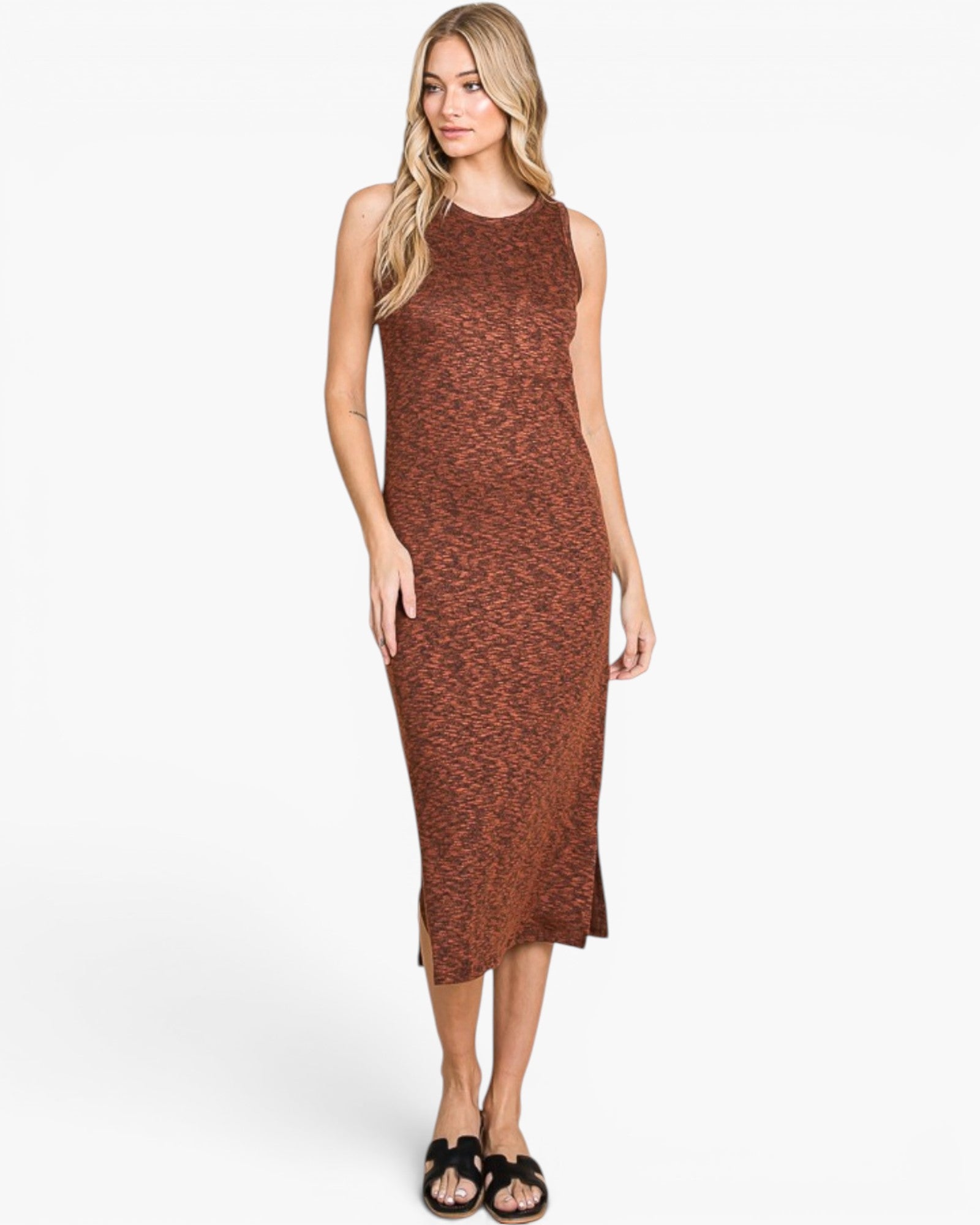 A woman modeling a sleeveless, high-neck midi dress with a rust-brown and terracotta textured pattern, paired with black slide sandals, against a plain white studio background.