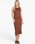 A woman modeling a sleeveless, high-neck midi dress with a rust-brown and terracotta textured pattern, paired with black slide sandals, against a plain white studio background.