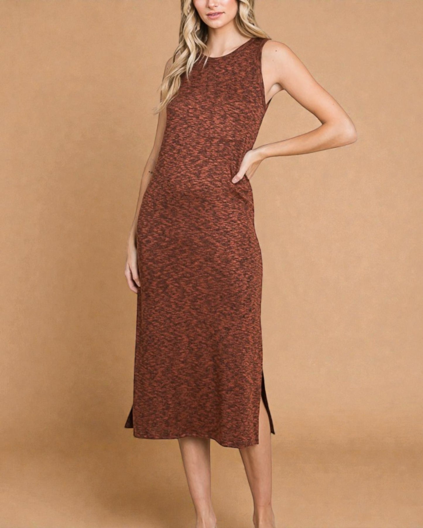 Woman wearing a brown patterned dress against a beige background