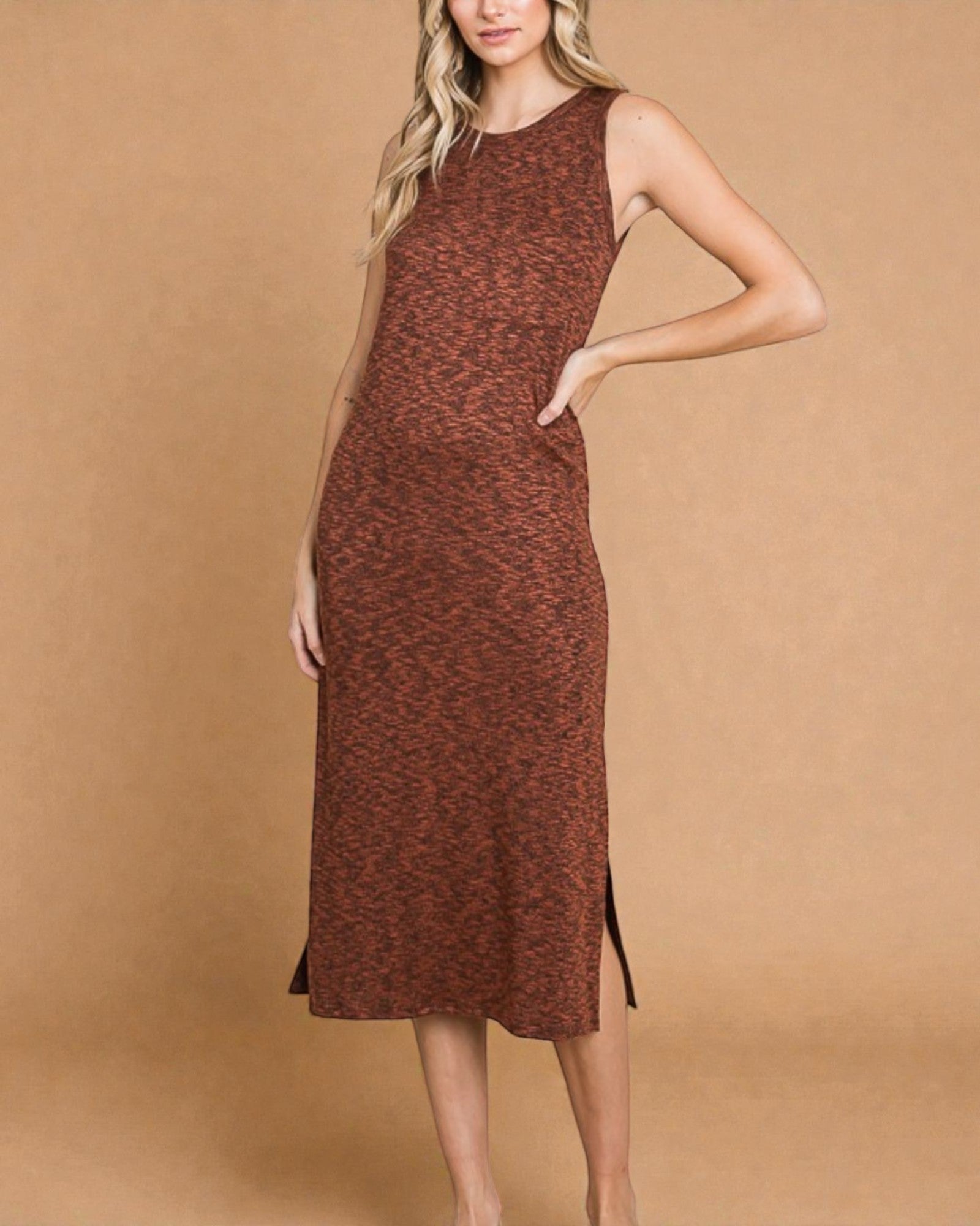 Woman wearing a brown patterned dress against a beige background