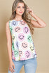 Woman wearing a sleeveless top with smiley face pattern against a beige background