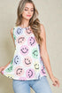 Woman wearing a sleeveless top with smiley face pattern against a beige background