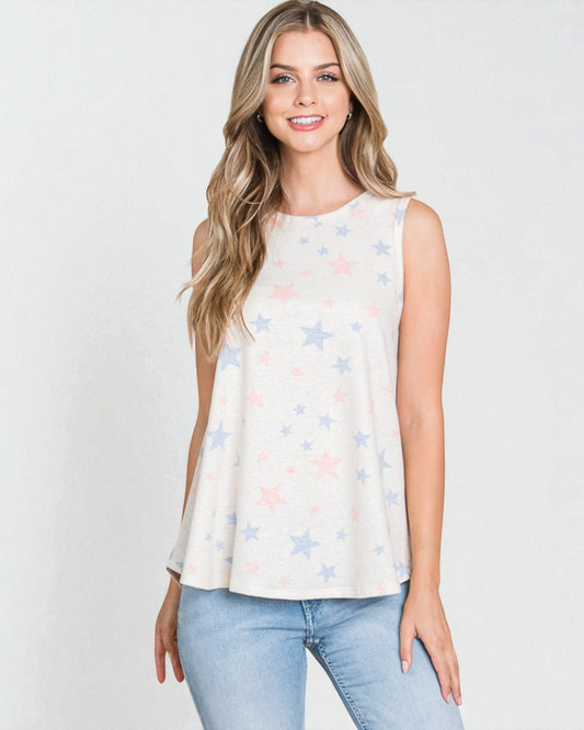 Woman wearing a sleeveless top with star pattern and light blue jeans on a white background