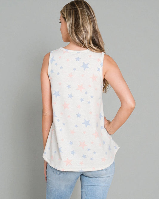 Woman wearing a sleeveless top with star pattern against a gray background