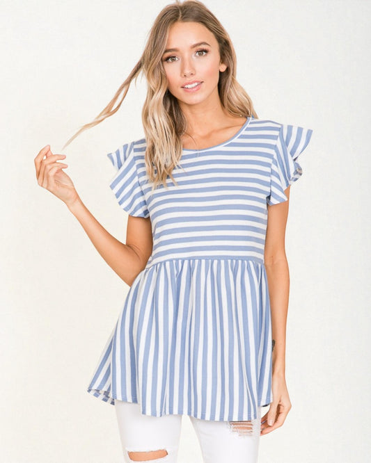 Woman wearing a blue and white striped dress against a white background