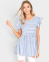Woman wearing a blue and white striped dress against a plain background