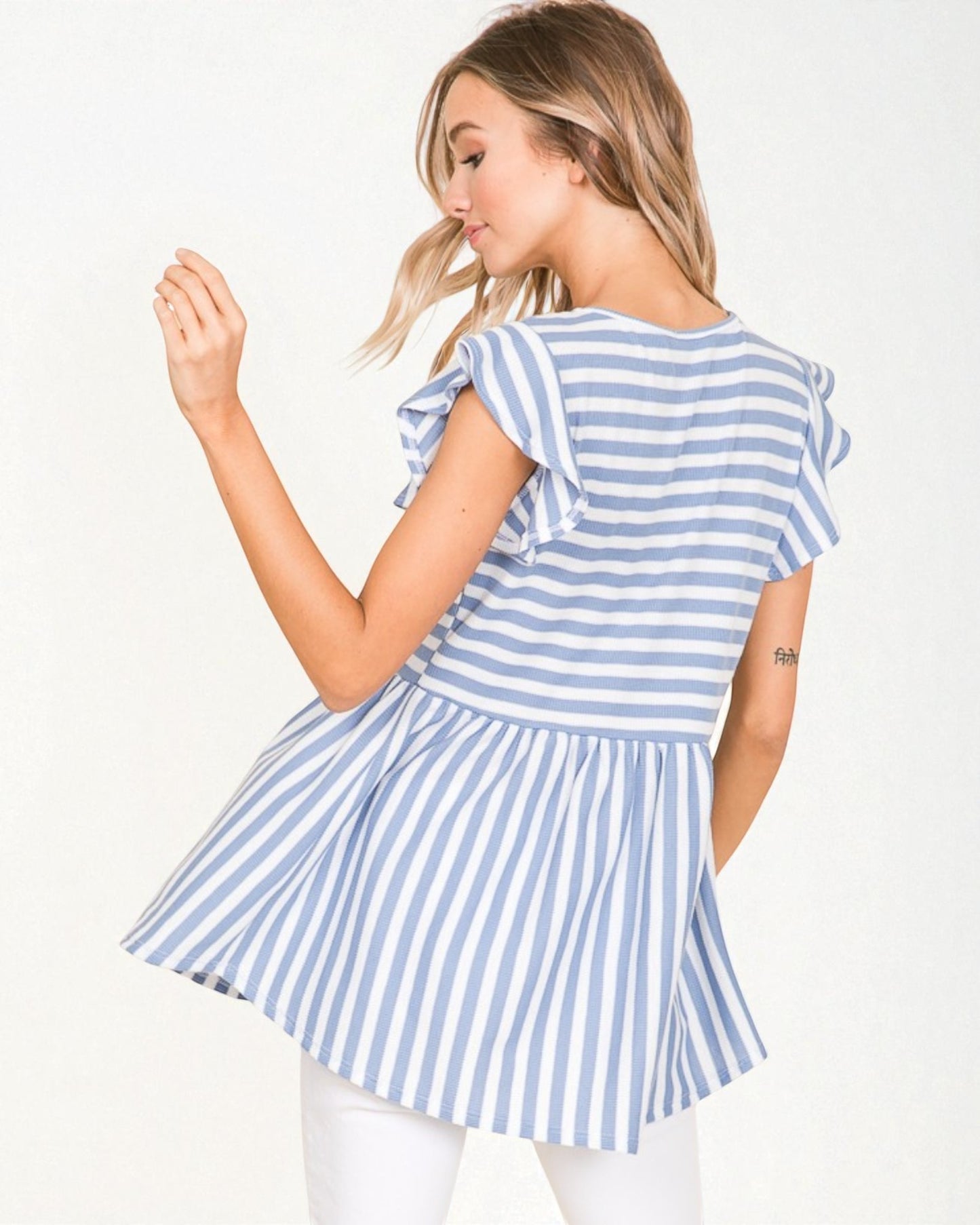 Woman wearing a blue and white striped dress on a white background