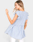 Woman wearing a blue and white striped dress against a plain background
