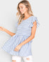 Woman wearing a blue and white striped dress against a plain background