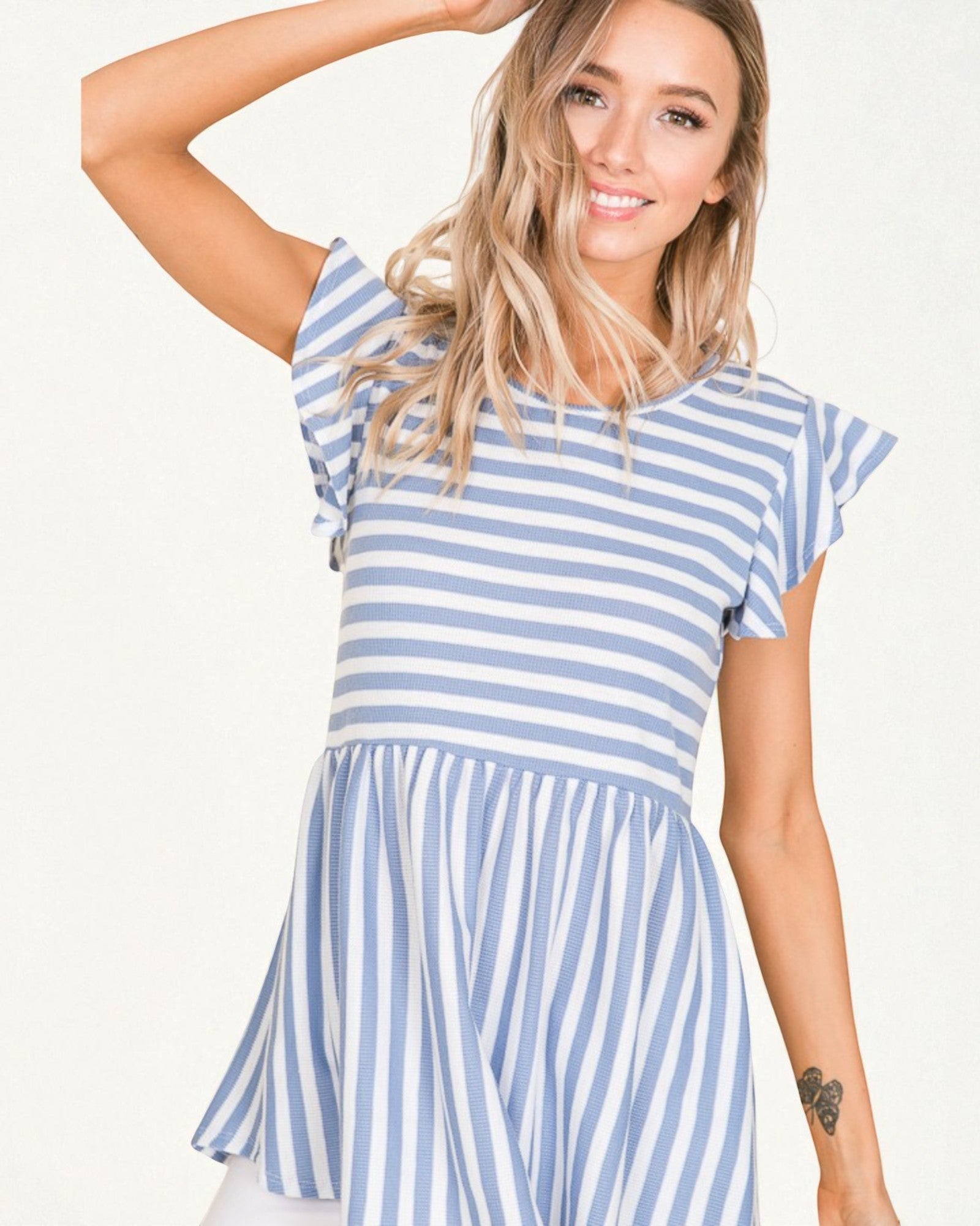 Woman wearing a blue and white striped dress on a white background