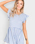 Woman wearing a blue and white striped dress against a plain background