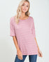 Woman wearing a pink and white striped shirt against a plain background