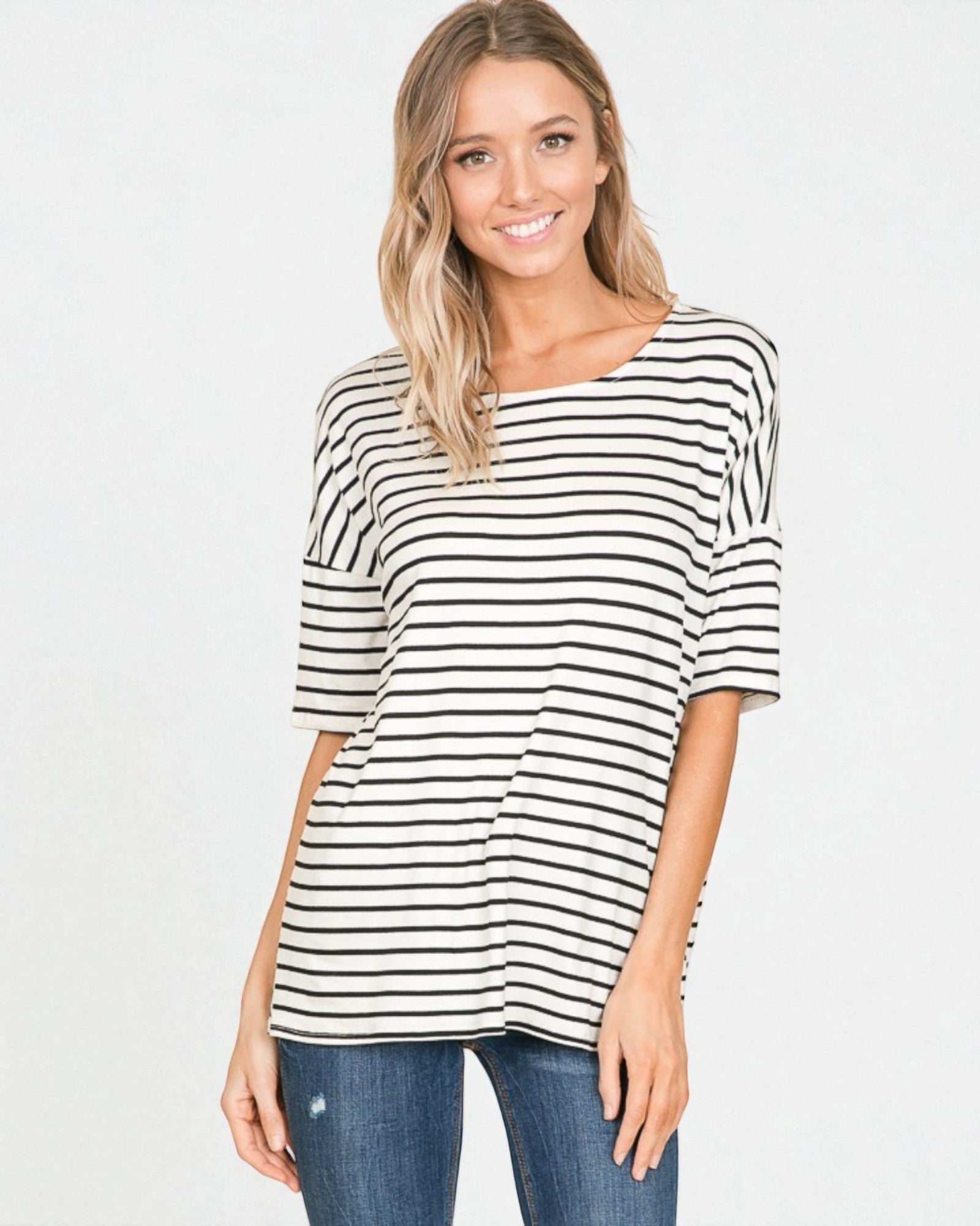 Woman wearing a black and white striped shirt on a white background