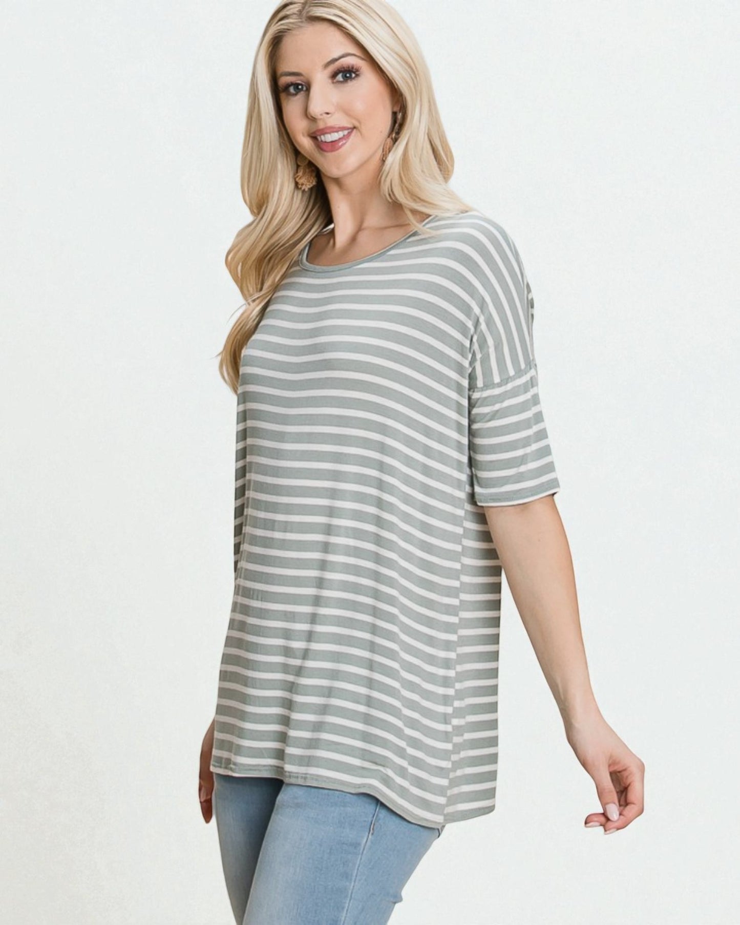 Woman wearing a gray and white striped shirt on a white background