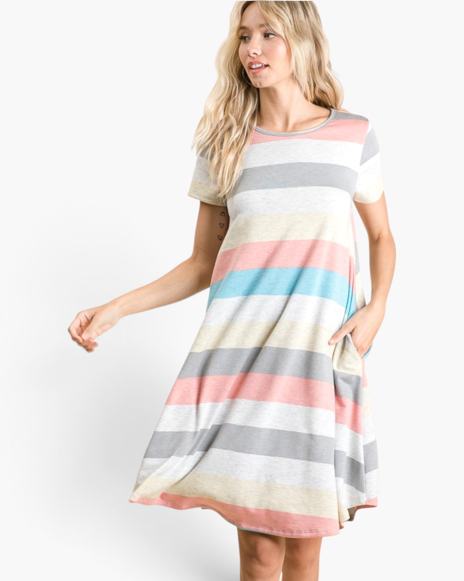 A woman modeling a short-sleeve, knee-length A-line dress with horizontal pastel stripes in pink, light blue, gray, cream, and white, set against a plain white studio background.