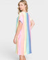 Woman wearing a pastel striped dress on a plain background