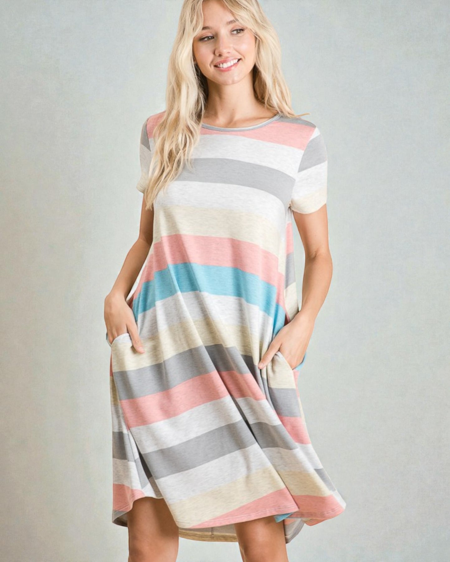 Woman wearing a striped dress with a plain background