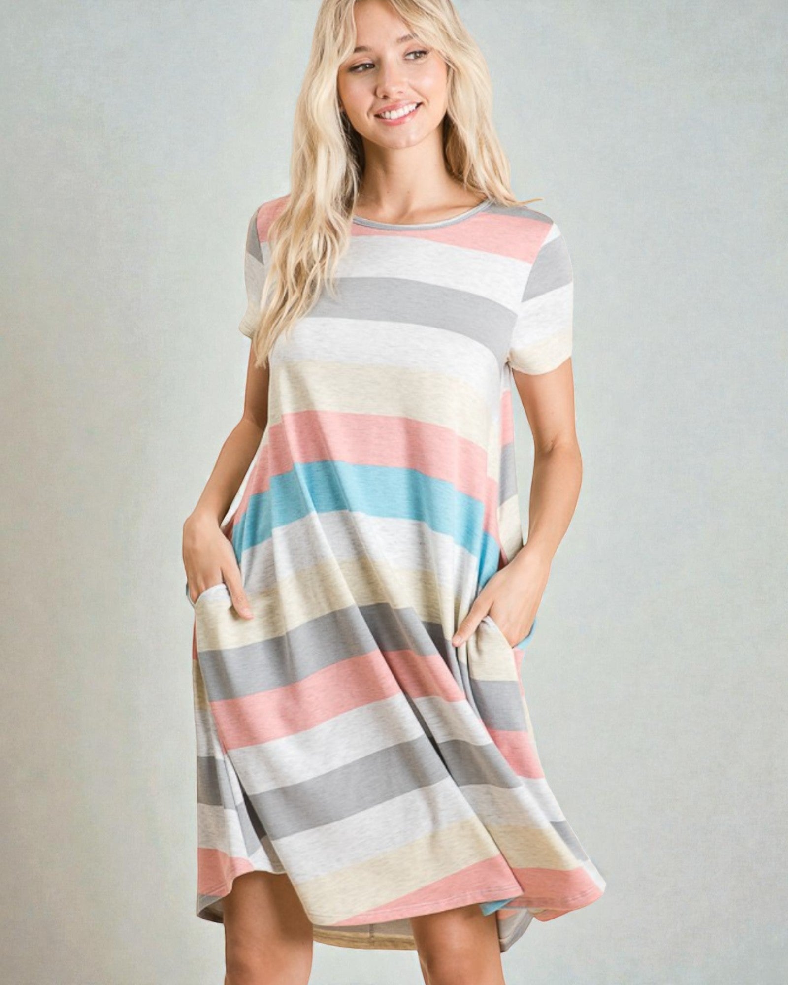 Woman wearing a striped dress with a plain background