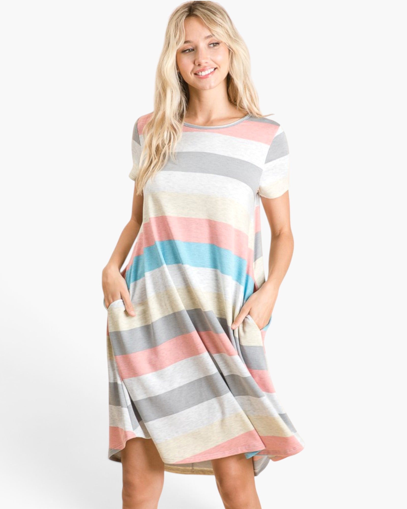 A woman modeling a short-sleeve, knee-length dress with horizontal pastel stripes in pink, light blue, gray, cream, and white, featuring side pockets, against a plain white studio background.