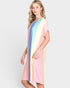 Woman wearing a colorful striped dress on a white background