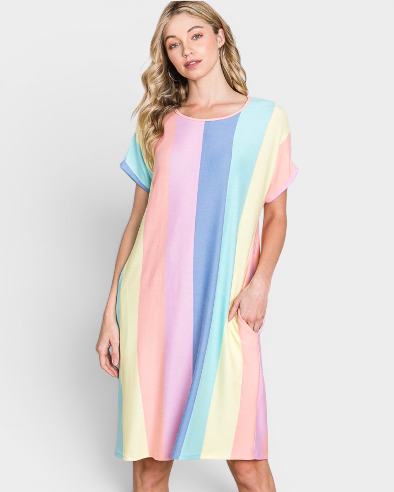 Woman wearing a pastel striped dress on a white background