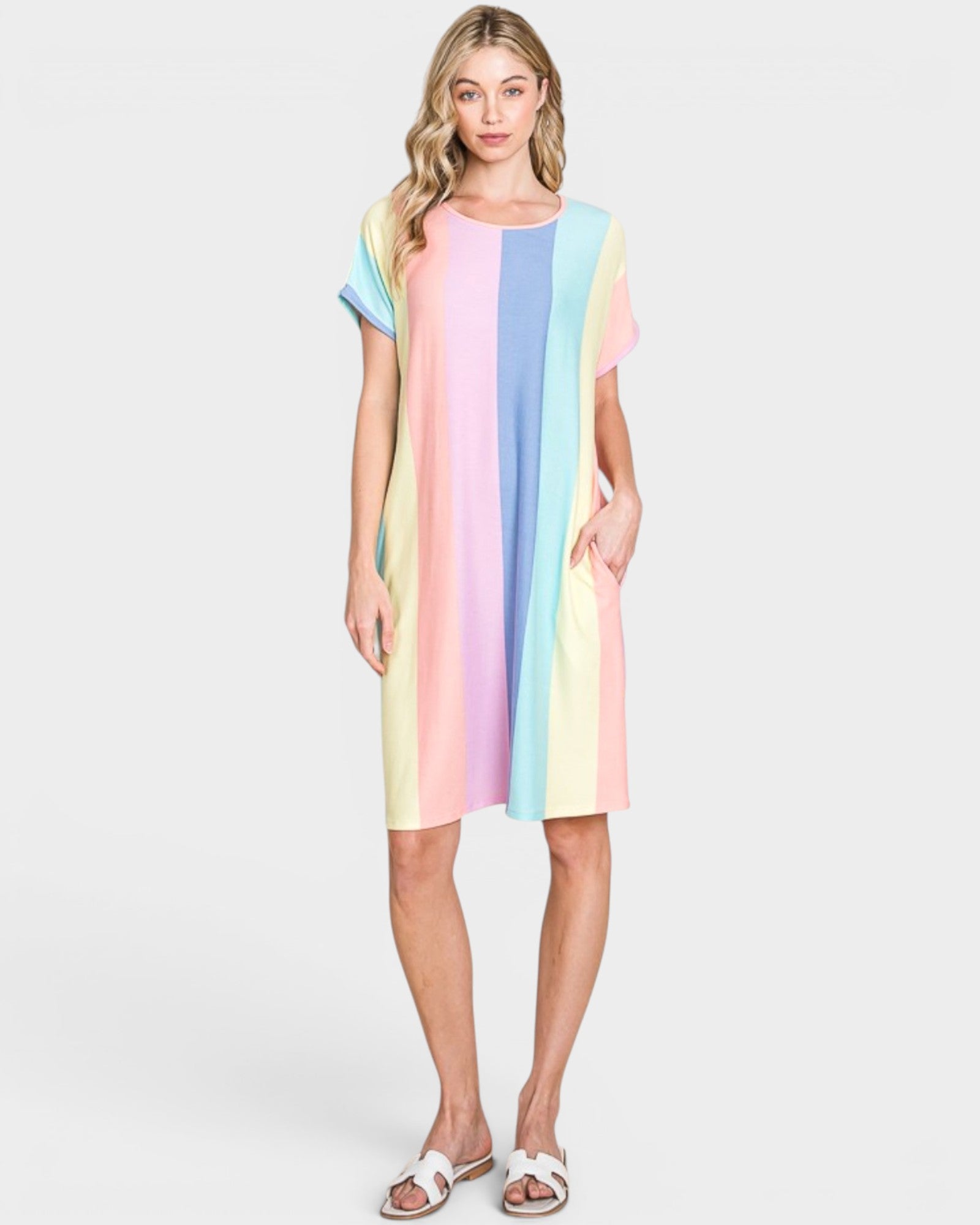 Woman wearing a colorful striped dress on a white background