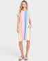 Woman wearing a colorful striped dress on a white background