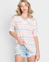 Woman wearing a striped shirt and denim shorts on a plain background