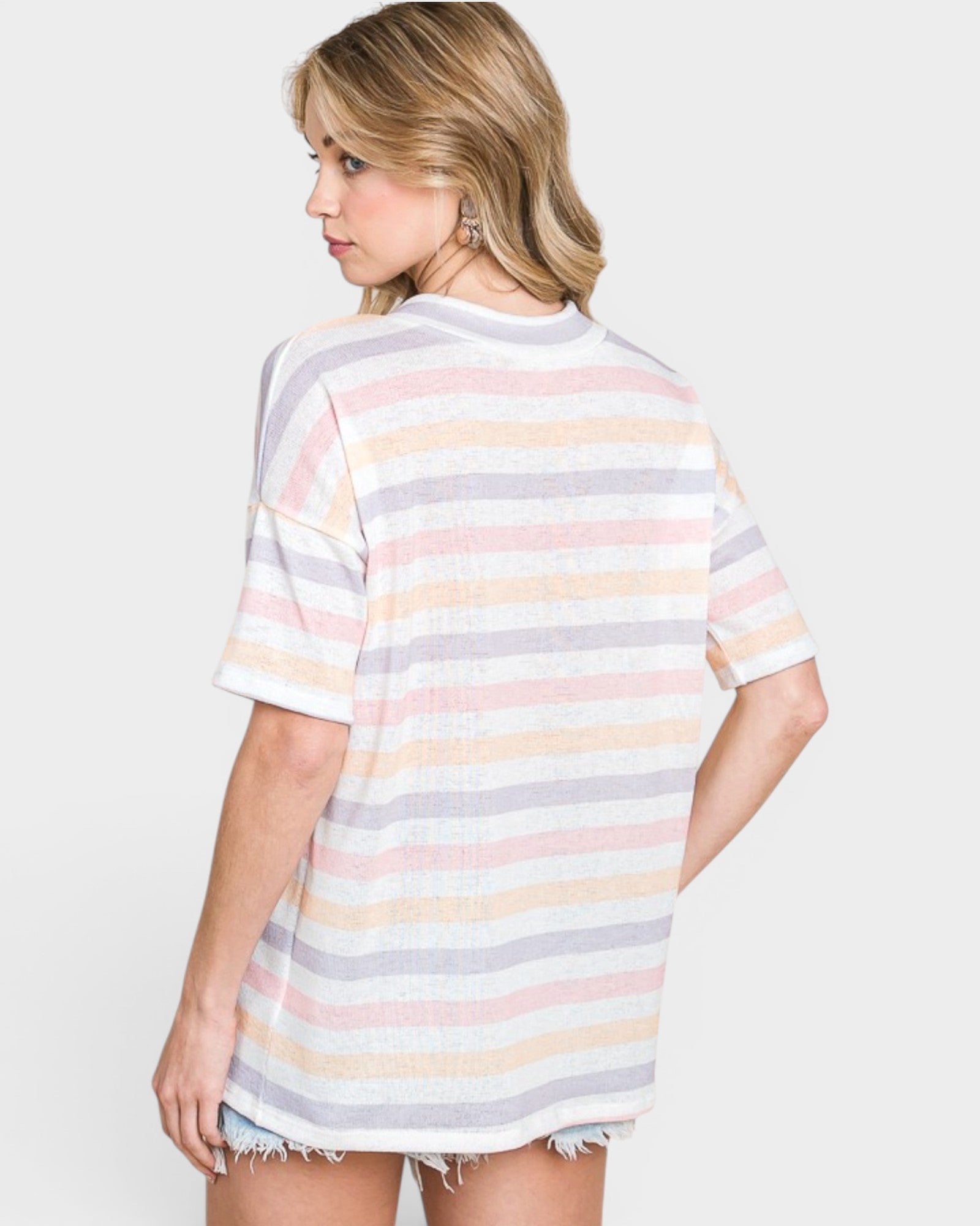 Woman wearing a striped t-shirt with a plain background