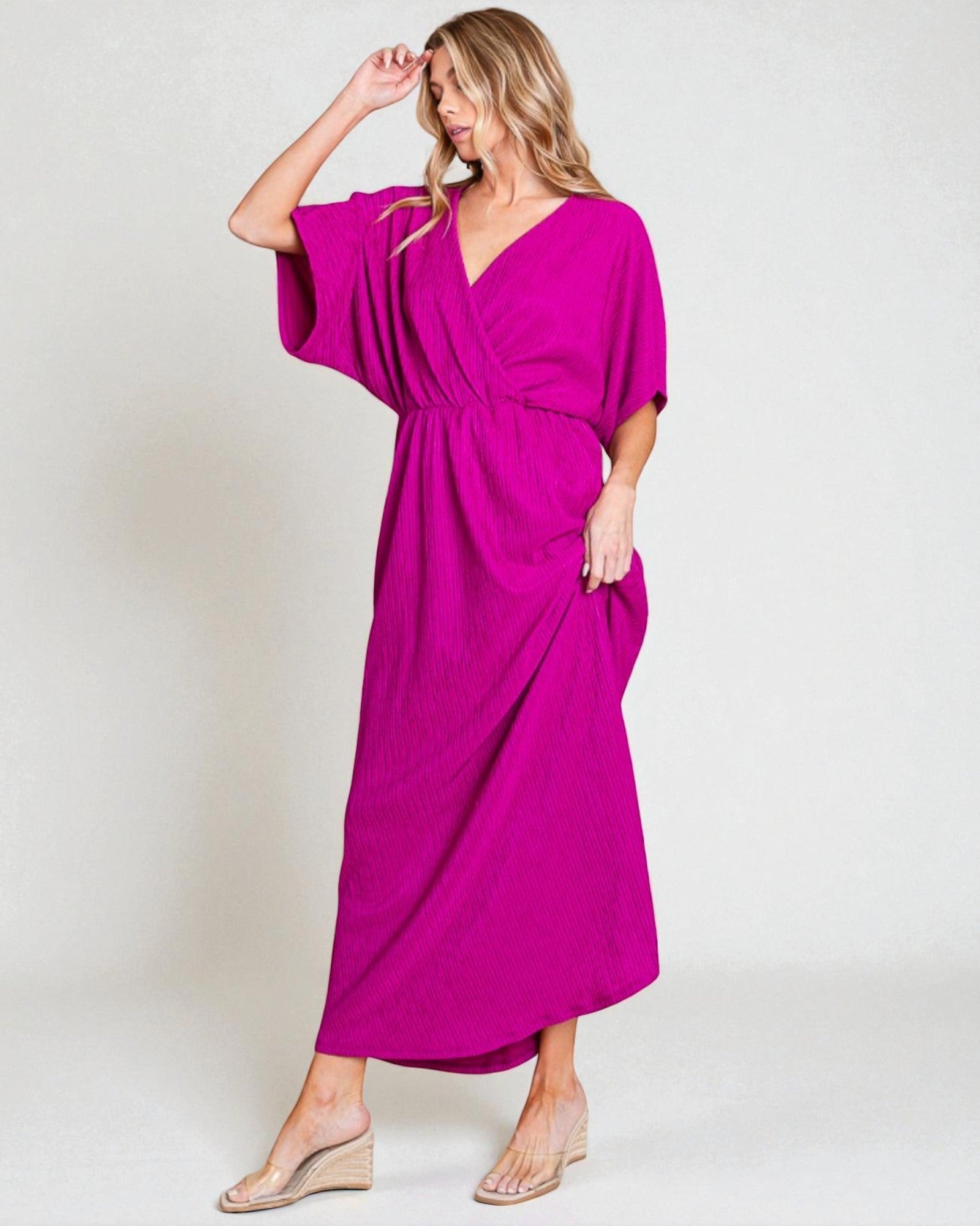 Woman wearing a bright pink dress on a white background