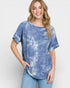 Woman wearing a blue tie-dye shirt and jeans on a white background