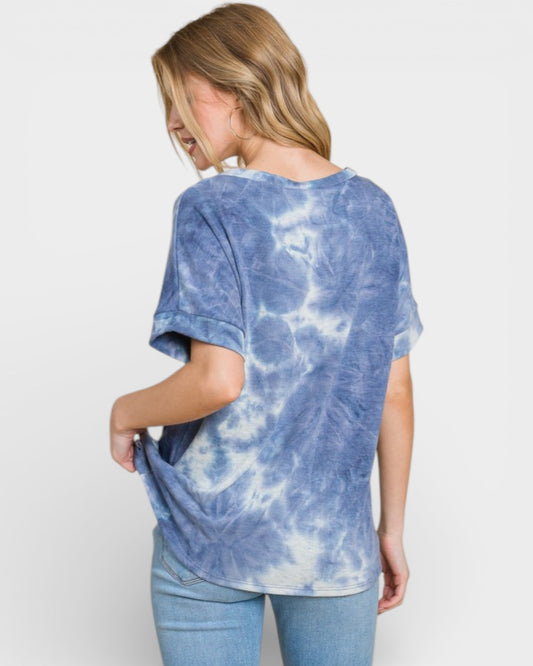 Woman wearing a blue tie-dye t-shirt on a white background