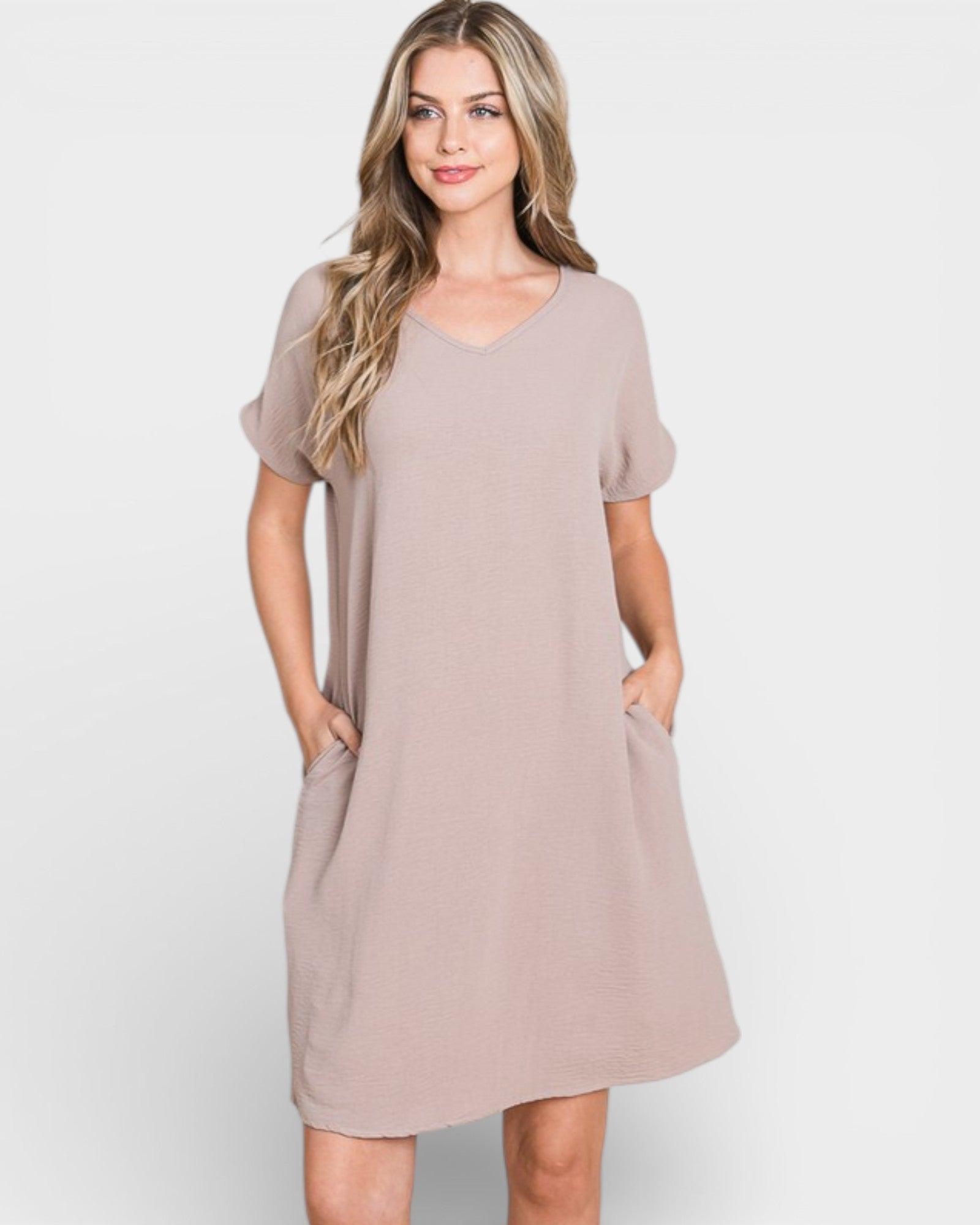 Woman wearing a beige dress on a white background