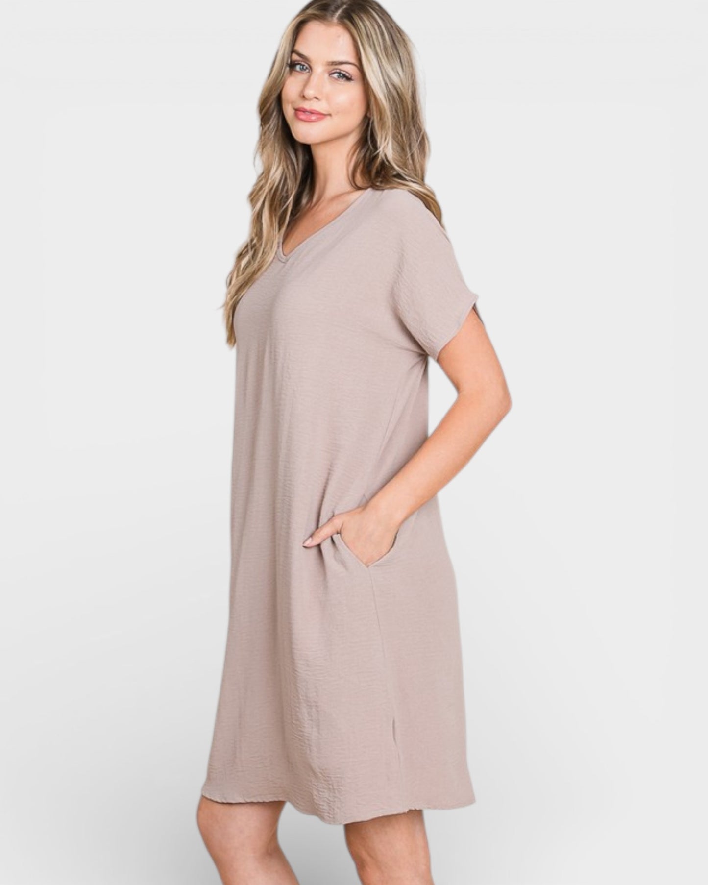 Woman wearing a beige dress on a white background