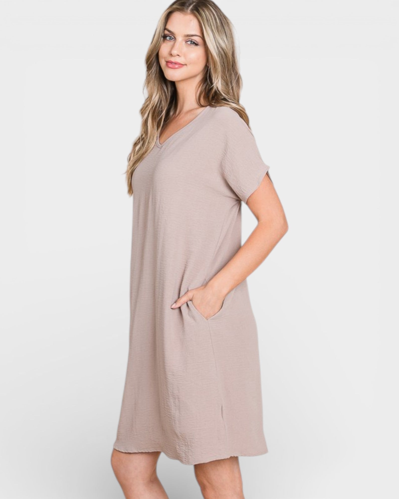 Woman wearing a beige dress on a white background