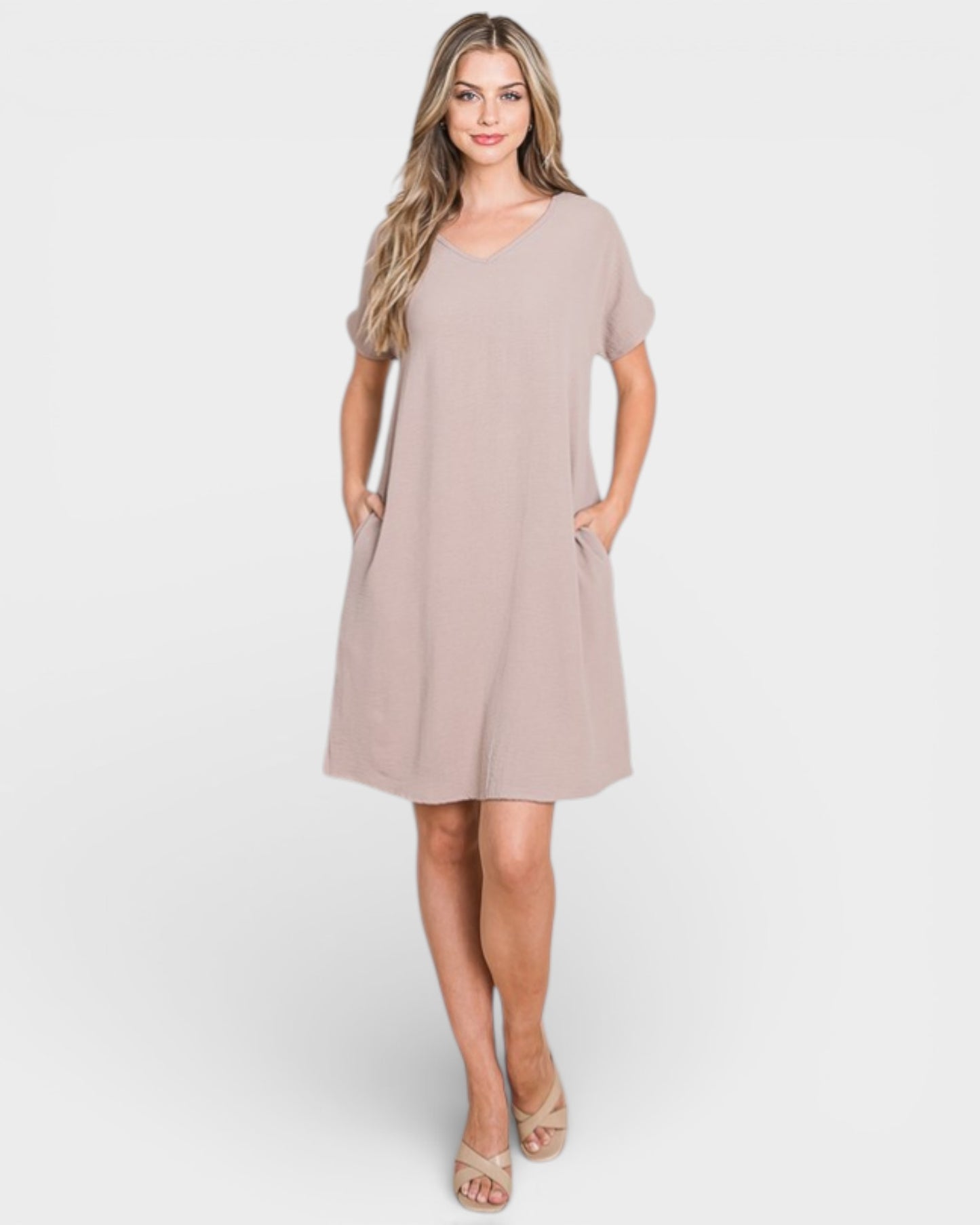 Woman wearing a beige dress on a white background