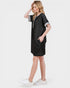 Woman wearing a black dress with white sneakers on a white background