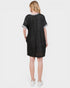 Person wearing a black dress with gray trim on a white background