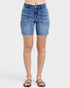 Blue denim shorts worn by a person on a white background