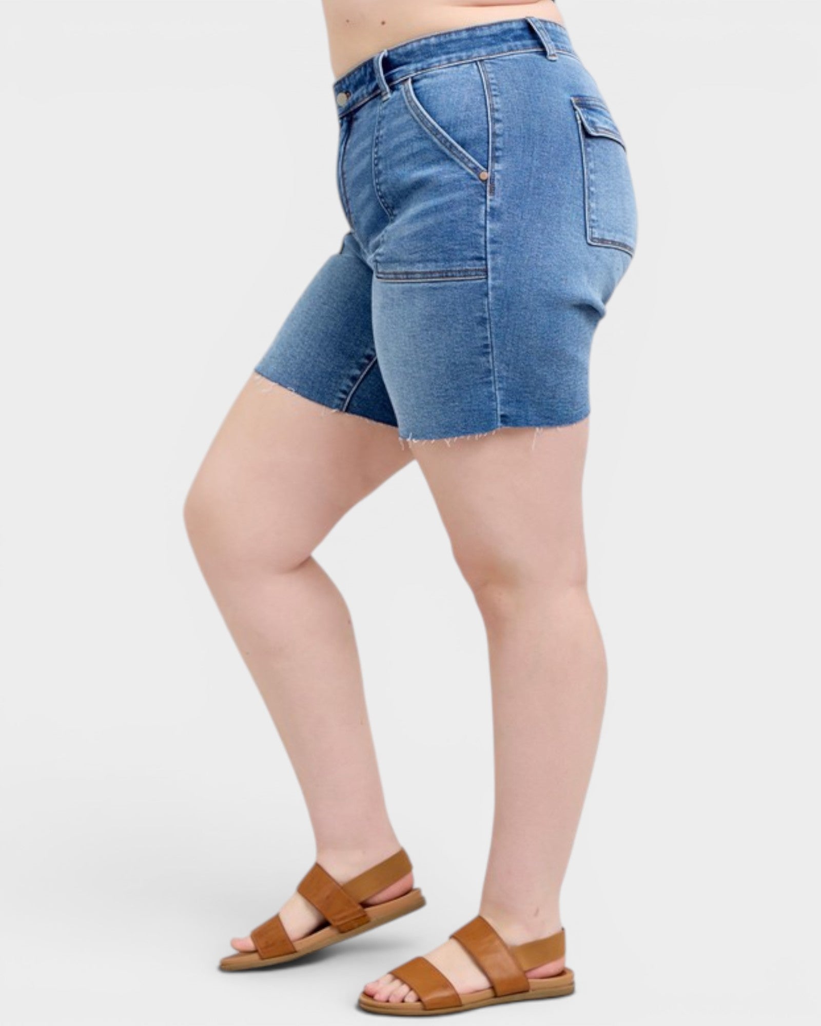 Person wearing blue denim shorts on a white background