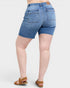 Blue denim shorts worn by a person on a white background