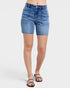Blue denim shorts worn by a person on a white background