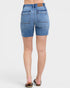 Denim shorts worn by a person on a white background