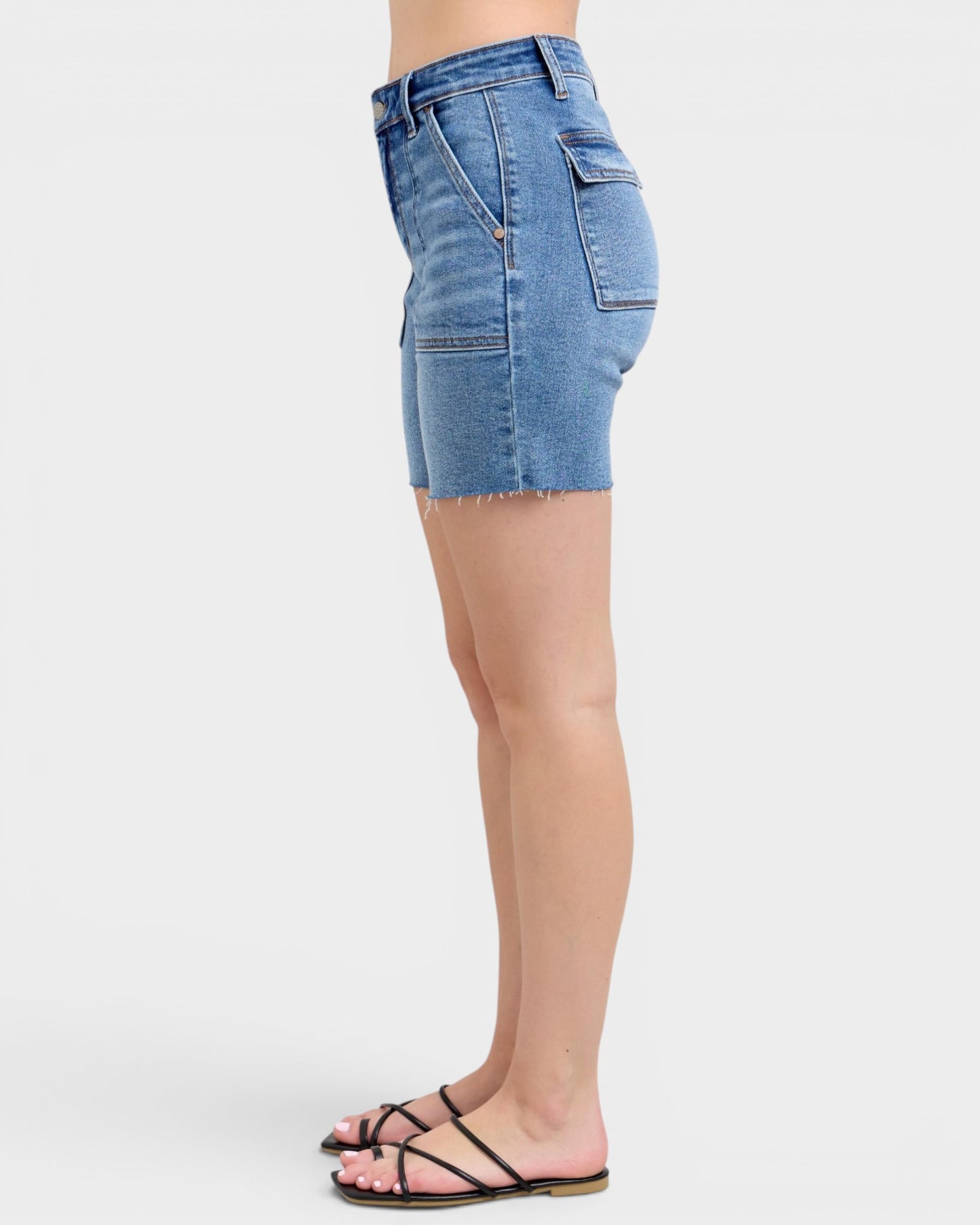 Denim shorts worn by a person on a white background